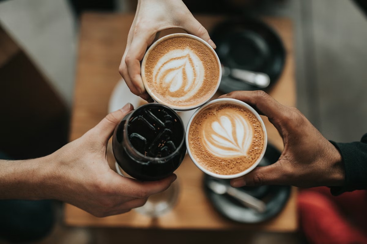 People sharing coffee from a local cafe